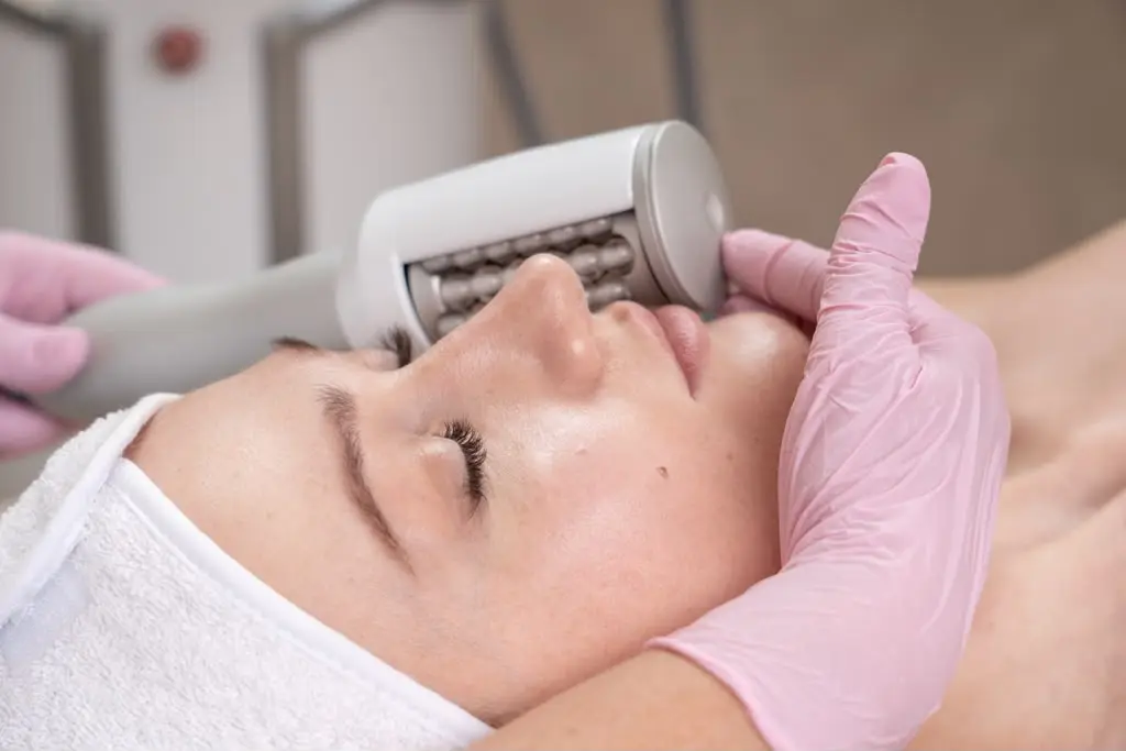 A facial session with the small roller handpiece worked along the cheekbone